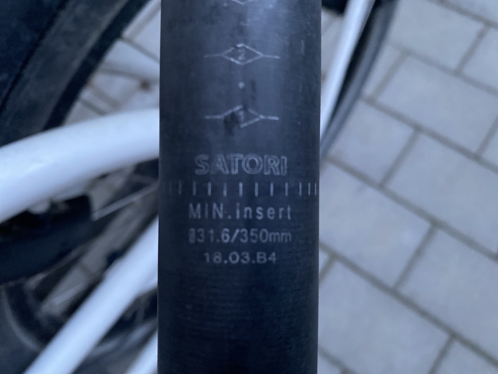 Schriftzug „Satori“ auf dem Rohr der ausgebauten Sattelstütze, oberhalb der Markierung MIN. insert